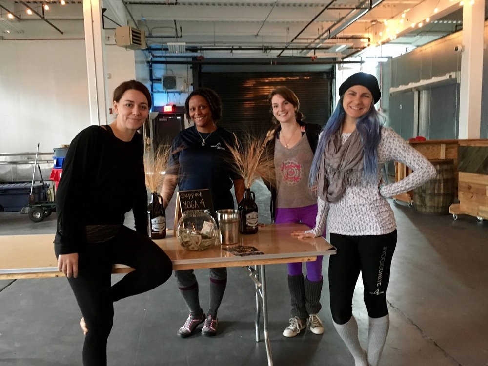 Four women standing at a table