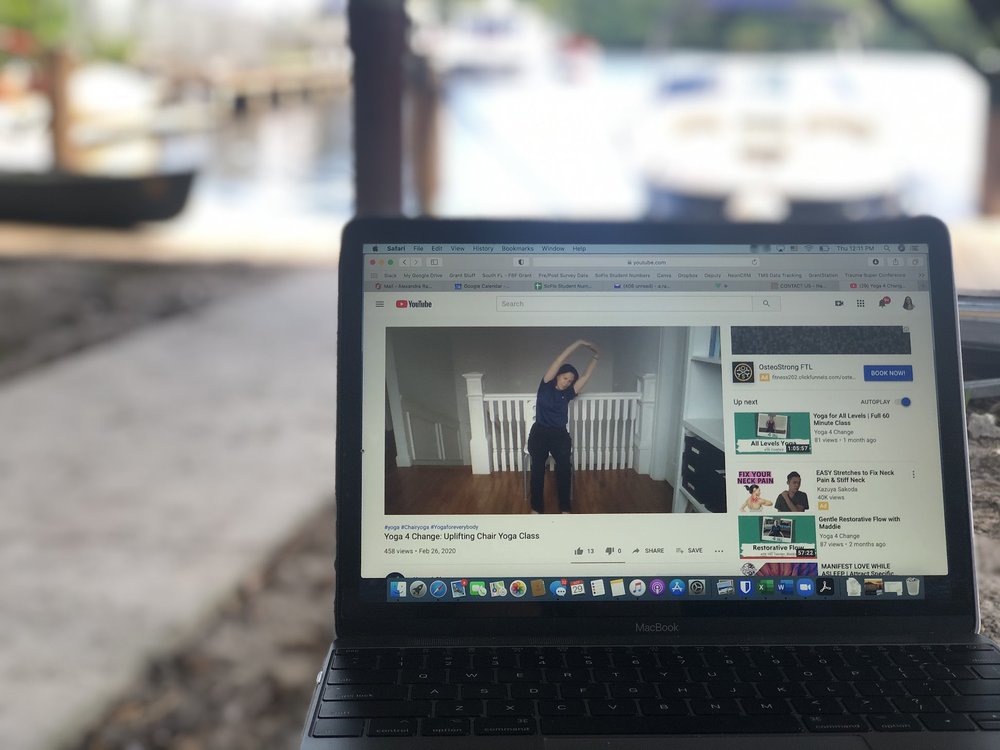 Image on laptop of person doing yoga
